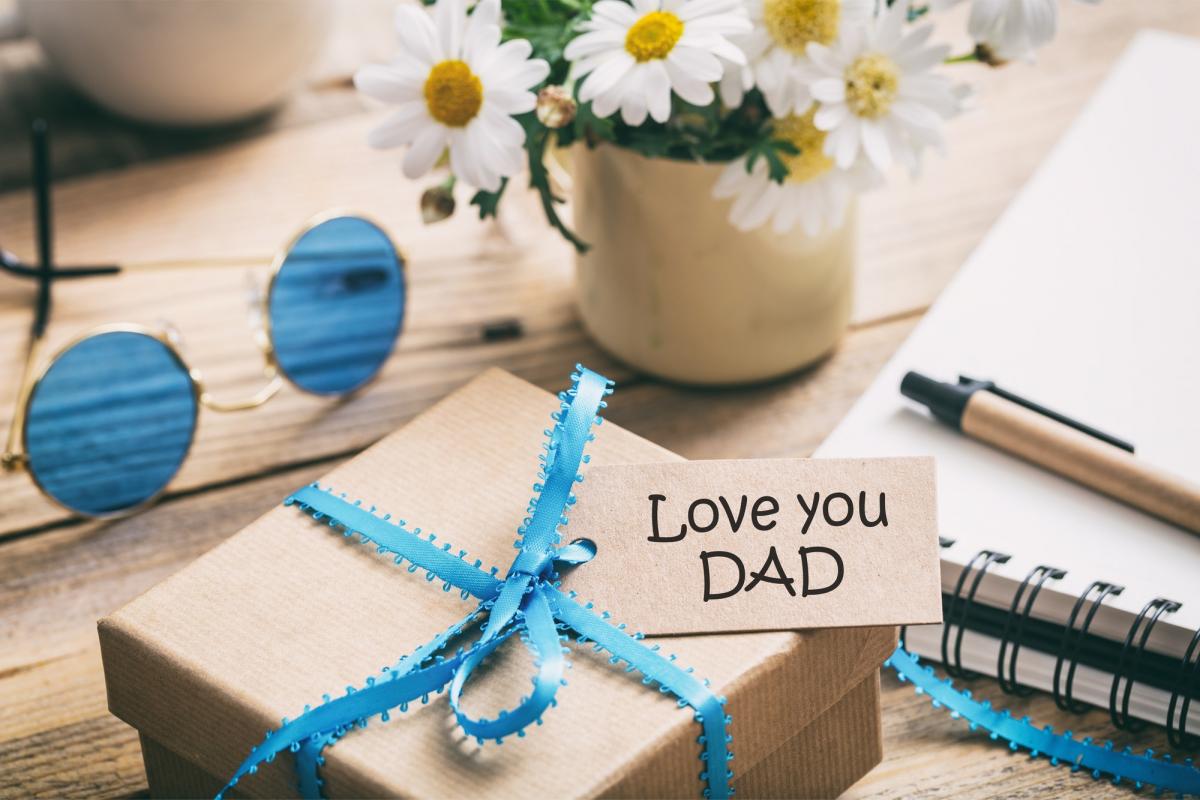 gift box with love you dad tag, blur office desk background